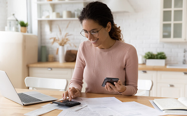 Woman wearing glasses computing her finances