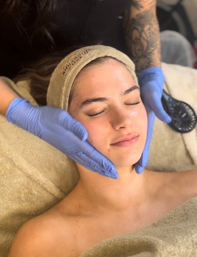 Woman getting a liaquid microneedling treatment at MediZen Institute